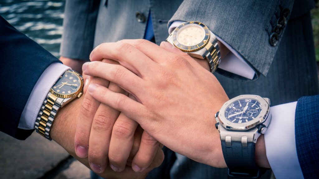 Luxury watches at the wrists of many managers