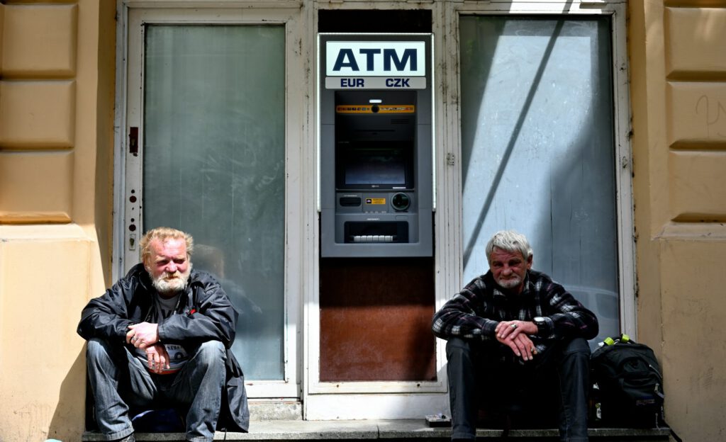 people sitting infront of an ATM