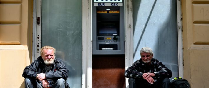 people sitting infront of an ATM