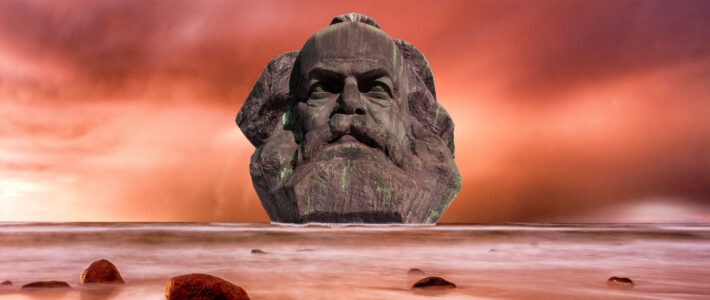 Ein Kopf von Karl Marx im Meer mit rotem Himmel
