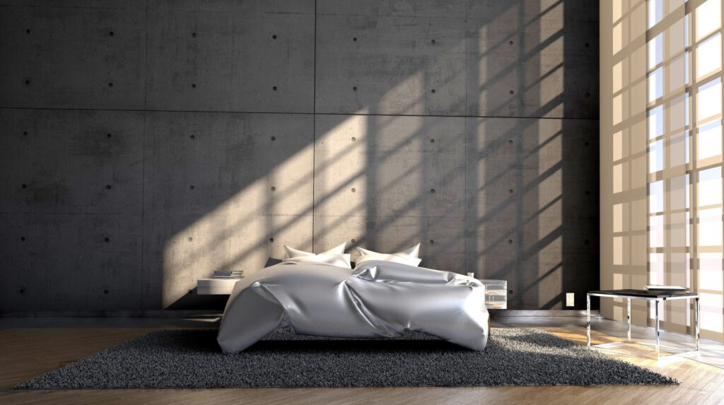 Ein grosses Schlafzimmer mit einem Bett und grosser Fensterfront
