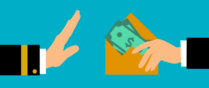 Rüge zum Korruptionskampf von Seco und Deza Eine Hand lehnt einen Briefumschlag mit Geldscheinen ab