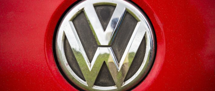 Logo von VW vor rotem Hintergrund