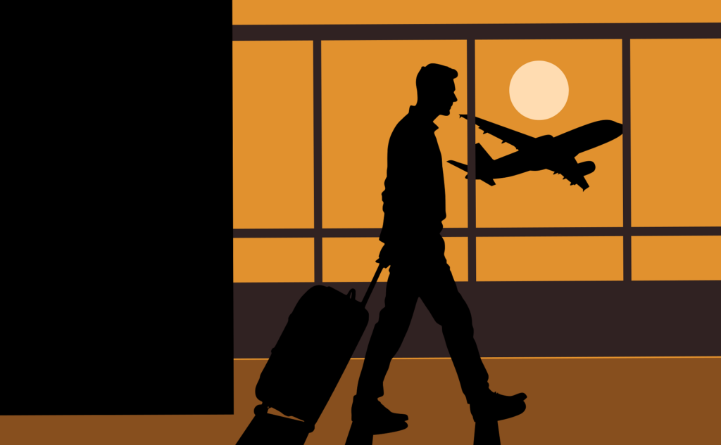 ein Mann mit einem Rollkoffer an einem Flughafen