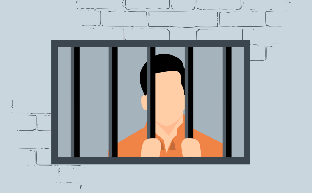 Eine Gefangener in orangen Pullover hinter einem vergitteren Fenster