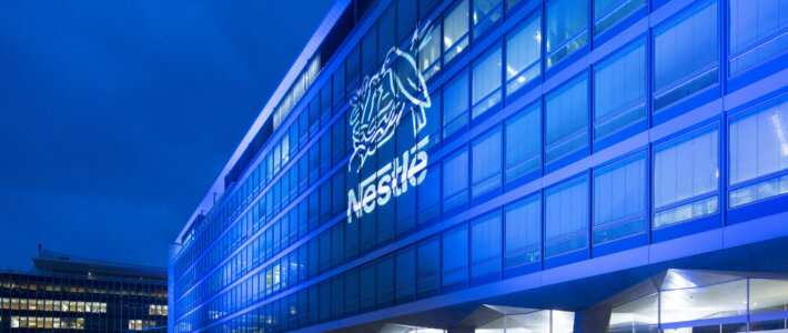 Gigantischer Gewinneinbruch bei Nestlé Nestlé-Logo an einem Gebäude in Vevey