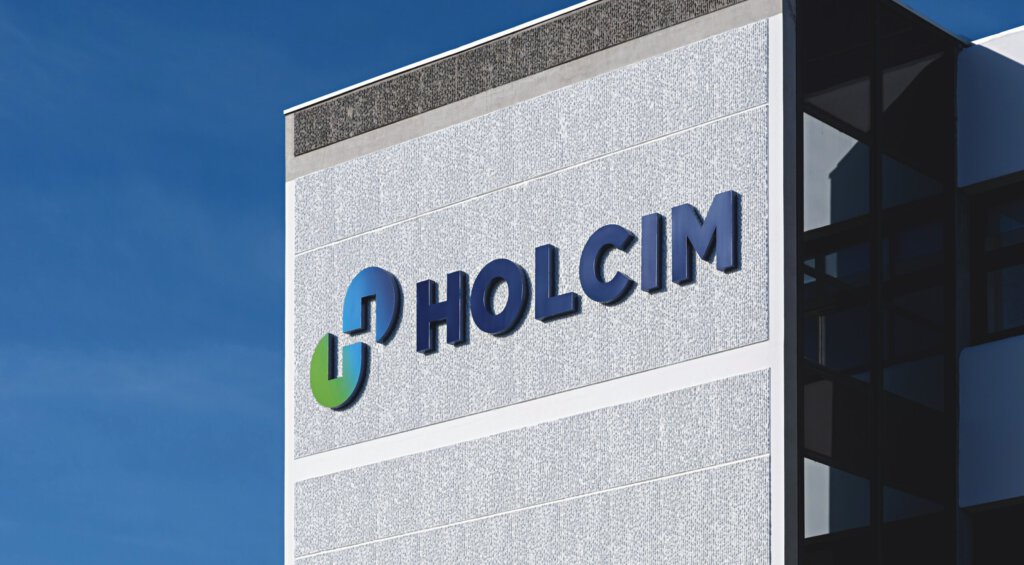 Logo von Holcim an einem Gebäude vor blauem Himmel