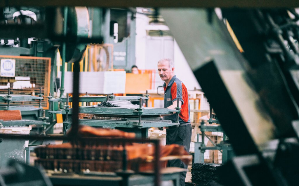ein Arbeiter in einer Fabrikhalle